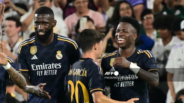 Real Madrid's Brazilian midfielder Vini Jr. (R) celebrates scoring his team's third goal with teammates during the friendly football match between Real Madrid and AC Milan at the Rose Bowl in Pasadena, California, on July 23, 2023. (Photo by Frederic J. BROWN / AFP)