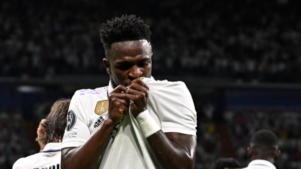 Real Madrid's Brazilian forward Vinicius Junior celebrates with teammates scoring his team's first goal during the UEFA Champions League semi-final first leg football match between Real Madrid CF and Manchester City at the Santiago Bernabeu stadium in Madrid on May 9, 2023. (Photo by JAVIER SORIANO / AFP)