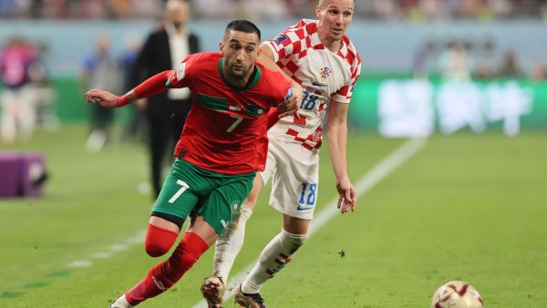 Morocco's midfielder #07 Hakim Ziyech (L) and Croatia's forward #18 Mislav Orsic fight for the ball during the Qatar 2022 World Cup third place play-off football match between Croatia and Morocco at Khalifa International Stadium in Doha on December 17, 2022. (Photo by KARIM JAAFAR / AFP)