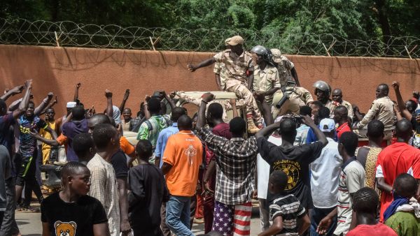 Protesters cheer Nigerien troops as they gather in front of the French Embassy in Niamey during a demonstration that followed a rally in support of Niger's junta in Niamey on July 30, 2023. (Photo by AFP) Niger