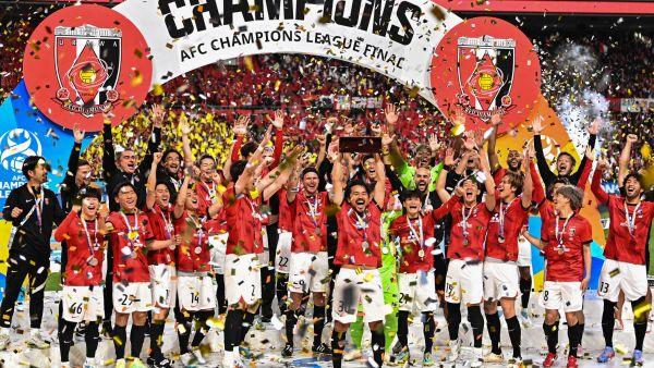 Urawa Red Diamonds players celebrate with the trophy after their victory against Al-Hilal in the second leg of the AFC Champions League final at Saitama Stadium in Saitama on May 6, 2023. (Photo by Philip FONG / AFP)