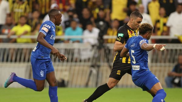 Ittihad's forward Abderrazak Hamdallah (C) is marked by Hilal's defender Ali al-Bulaihi (R) during a Saudi Pro League football match between al-Ittihad and al-Hilal at the King Abdullah Sports City in Jeddah on May 23, 2022. (Photo by AFP)