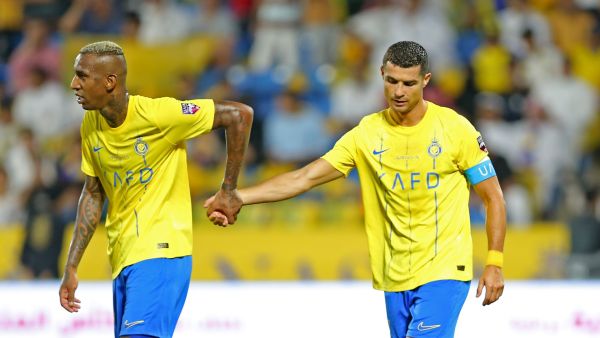 Nassr's Portuguese forward Cristiano Ronaldo walks with Nassr's Brazilian forward Talisca (L) during the 2023 Arab Club Champions Cup semi-final football match between Saudi Arabia's Al-Nassr and Iraq's Al-Shorta at Prince Sultan bin Abdul Aziz Stadium in Abha on August 9, 2023. (Photo by Abdullah Mahdi / AFP)