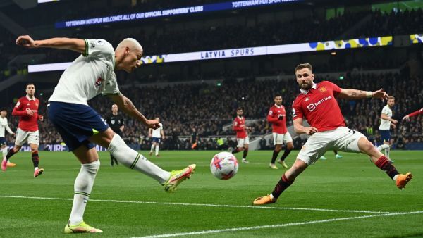 Tottenham Hotspur's Brazilian striker Richarlison (L) crosses the ball during the English Premier League football match between Tottenham Hotspur and Manchester United at Tottenham Hotspur Stadium in London, on April 27, 2023. (Photo by Glyn KIRK / AFP) 