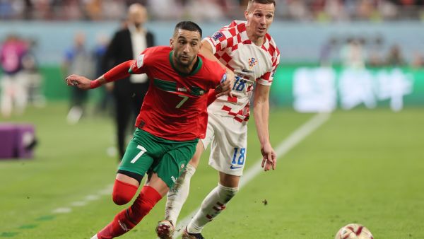 Morocco's midfielder #07 Hakim Ziyech (L) and Croatia's forward #18 Mislav Orsic fight for the ball during the Qatar 2022 World Cup third place play-off football match between Croatia and Morocco at Khalifa International Stadium in Doha on December 17, 2022. (Photo by KARIM JAAFAR / AFP)