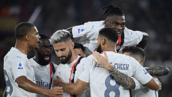 AC Milan's French forward #09 (3rd L) Olivier Giroud celebrates with teammates after scoring his team's first goal during the Italian Serie A football match between AS Roma and AC Milan at the Olympic stadium in Rome on September 1, 2023. (Photo by Filippo MONTEFORTE / AFP)