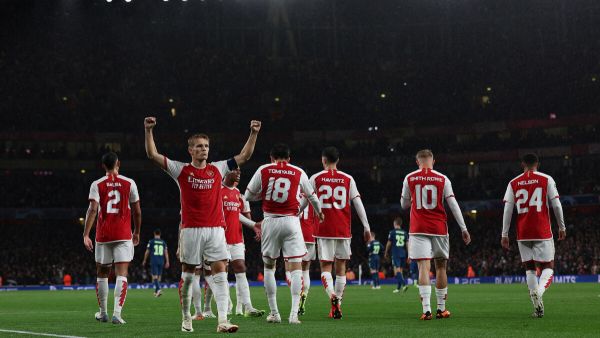 Arsenal's Norwegian midfielder #08 Martin Odegaard celebrates scoring the team's fourth goal during the UEFA Champions League Group B football match between Arsenal and PSV Eindhoven at the Arsenal Stadium in north London on September 20, 2023. (Photo by Adrian DENNIS / AFP)