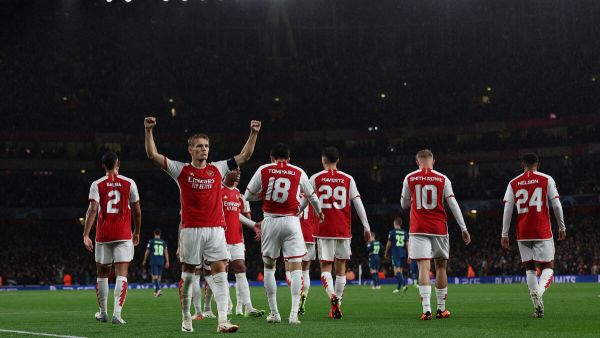 Arsenal's Norwegian midfielder #08 Martin Odegaard celebrates scoring the team's fourth goal during the UEFA Champions League Group B football match between Arsenal and PSV Eindhoven at the Arsenal Stadium in north London on September 20, 2023. (Photo by Adrian DENNIS / AFP)