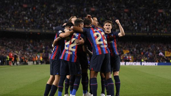Barcelona's players celebrate their team first goal during the Spanish league football match between FC Barcelona and Real Betis at the Camp Nou stadium in Barcelona on April 29, 2023. (Photo by Josep LAGO / AFP)