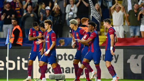 Barcelona's Portuguese defender #02 Joao Cancelo celebrates with teammates after scoring his team's third goal during the Spanish Liga football match between FC Barcelona and RC Celta de Vigo at the at the Estadi Olimpic Lluis Companys in Barcelona on September 23, 2023. (Photo by Pau BARRENA / AFP)