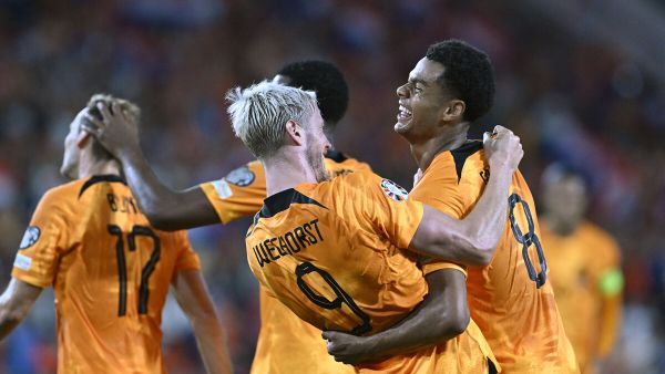 Netherlands' forward #08 Cody Gakpo (R) is congratulated by Netherlands' forward #09 Wout Weghorst (C) after scoring the Netherlands' second goal during the UEFA Euro 2024 football tournament group B qualification football match between the Netherlands and Greece at the Philips Stadium, in Eindhoven, on September 7, 2023. (Photo by JOHN THYS / AFP)