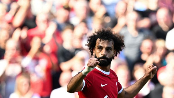 Liverpool's Egyptian striker #11 Mohamed Salah celebrates after scoring his team third goal during the English Premier League football match between Liverpool and Aston Villa at Anfield in Liverpool, north-west England on September 3, 2023. (Photo by Paul ELLIS / AFP)