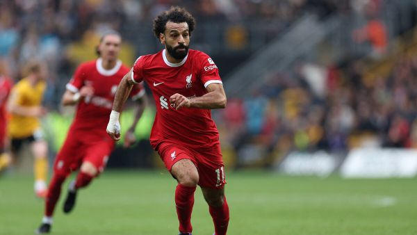Liverpool's Egyptian striker #11 Mohamed Salah runs with the ball during the English Premier League football match between Wolverhampton Wanderers and Liverpool at the Molineux stadium in Wolverhampton, central England on September 16, 2023. (Photo by Adrian DENNIS / AFP)