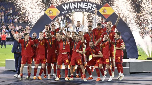 Spain's players celebrate on the podium with the UEFA Nations League cup after winning the penalty shootouts and the UEFA Nations League final football match between Croatia and Spain at the De Kuip Stadium in Rotterdam on June 18, 2023. (Photo by JOHN THYS / AFP)