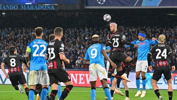 AC Milan's French defender Theo Hernandez goes for a header during the UEFA Champions League quarter-finals second leg football match between SSC Napoli and AC Milan on April 18, 2023 at the Diego-Maradona stadium in Naples. (Photo by Alberto PIZZOLI / AFP)