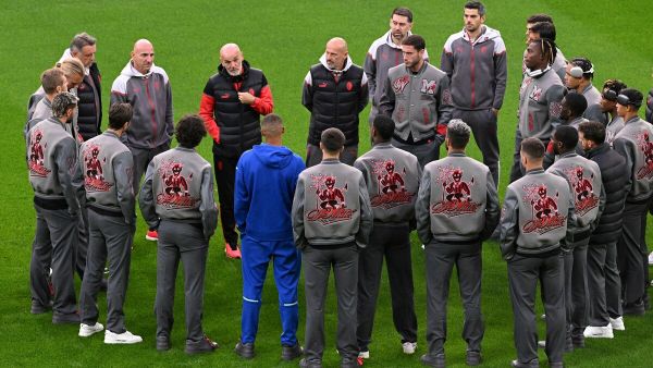 AC Milan's Italian coach Stefano Pioli (back 3L) talks to his players during their walk on the pitch on the eve of their UEFA Champions League football match between Borussia Dortmund and AC Milan at the Signal Iduna Park stadium in Dortmund, western Germany on October 3, 2023. (Photo by Ina FASSBENDER / AFP)