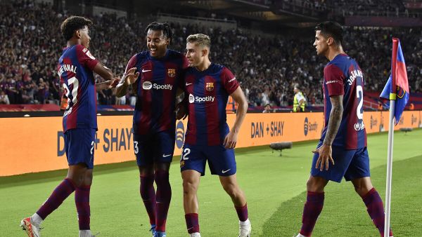 Barcelona's Spanish forward #27 Lamine Yamal and teammates celebrate Sevilla's Spanish defender #04 Sergio Ramos' owngoal during the Spanish Liga football match between FC Barcelona and Sevilla FC at the Estadi Olimpic Lluis Companys in Barcelona on September 29, 2023. (Photo by Pau BARRENA / AFP)