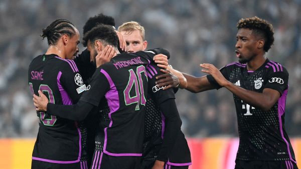 Bayern Munich's players celebrate Bayern Munich's German midfielder #42 Jamal Musiala (hidden) after he scored the 1-1 goal during the UEFA Champions League Group A football match between FC Copenhagen and FC Bayern Munich in Copenhagen, Denmark on October 3, 2023. (Photo by Sergei GAPON / AFP)