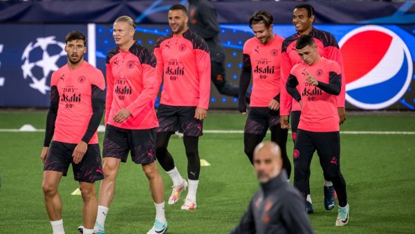 Manchester City's player (L-R) Portuguese defender #03 Ruben Dias, Norwegian striker #09 Erling Haaland, English defender #02 Kyle Walker, English midfielder #10 Jack Grealish, Swiss defender #25 Manuel Akanji and English midfielder #47 Phil Foden walk behind Spanish manager Pep Guardiola (Front) during a training session on the eve of the UEFA Champions League Group G football match between Young Boys and Manchester City, at Wankdorf Stadium in Bern, on October 24, 2023. (Photo by Fabrice COFFRINI / AFP)