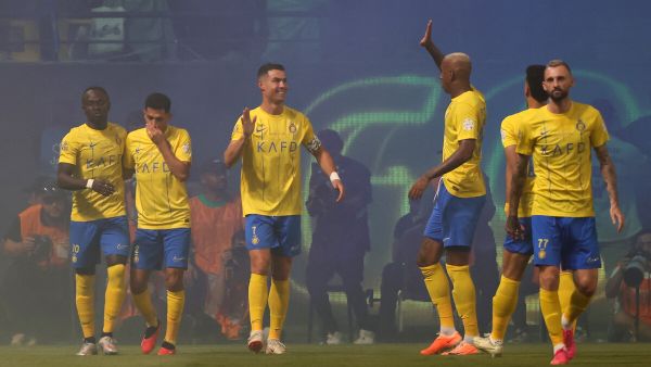 Nassr's players celebrate scoring during the Saudi Pro League football match between Al-Nassr and Al-Ahli at the King Saud University Stadium in Riyadh, on September 22, 2023. (Photo by Fayez NURELDINE / AFP)