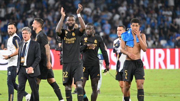 Real Madrid's German defender #22 Antonio Rudiger and Real Madrid's English midfielder #5 Jude Bellingham celebrate at the end of the UEFA Champions League 1st round day 2 Group C football match Napoli vs Real Madrid at the Diego Armando Maradona stadium in Naples on October 3, 2023. (Photo by Alberto PIZZOLI / AFP)