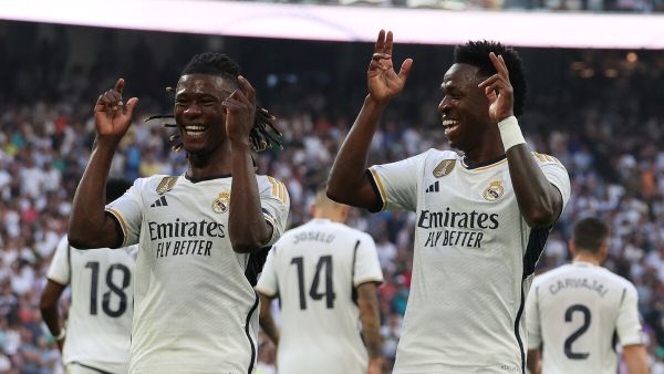 Real Madrid's Brazilian forward #07 Vinicius Junior (R) celebrates with Real Madrid's French midfielder #12 Eduardo Camavinga after scoring his team's third goal during the Spanish league football match between Real Madrid CF and CA Osasuna at the Santiago Bernabeu stadium in Madrid on October 7, 2023. (Photo by Pierre-Philippe MARCOU / AFP)