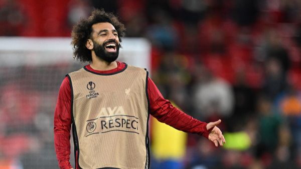 Liverpool's Egyptian striker #11 Mohamed Salah smiles as he warms up ahead of the UEFA Europa League group E football match between Liverpool and Royale Union Saint-Gilloise at Anfield in Liverpool, north west England on October 5, 2023. (Photo by Oli SCARFF / AFP)