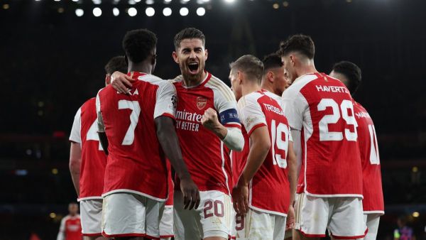 Arsenal's Italian midfielder #20 Jorginho (C) celebrates with teammates after their opening goal during the UEFA Champions League Group B football match between Arsenal and Sevilla at the Emirates Stadium in north London on November 8, 2023. (Photo by Adrian DENNIS / AFP)