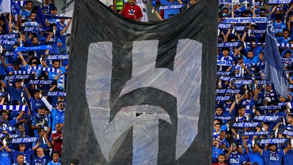 Supporters of al-Hilal cheer during the Saudi Pro League football match between Al-Hilal and Al-Shabab at Prince Faisal Bin Fahd Stadium in Riyadh on September 29, 2023. (Photo by Fayez NURELDINE / AFP)