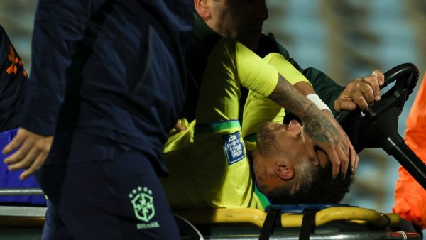Brazil's forward Neymar leaves the field crying in pain after an injury during the 2026 FIFA World Cup South American qualification football match between Uruguay and Brazil at the Centenario Stadium in Montevideo on October 17, 2023. (Photo by Pablo PORCIUNCULA / AFP)