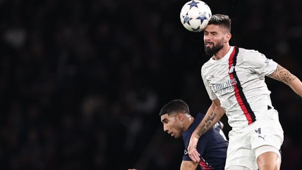 AC Milan's French forward #09 Olivier Giroud heads the ball next to Paris Saint-Germain's Moroccan defender #02 Achraf Hakimi during the UEFA Champions League Group F football match between Paris Saint-Germain (PSG) and AC Milan at the Parc de Princes in Paris on October 25, 2023. (Photo by FRANCK FIFE / AFP)