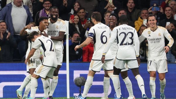 Real Madrid's Brazilian forward #11 Rodrygo (L) celebrates scoring his team's third goal during the UEFA Champions League group C football match between Real Madrid CF and SC Braga at the Santiago Bernabeu stadium in Madrid on November 8, 2023. (Photo by Pierre-Philippe MARCOU / AFP)