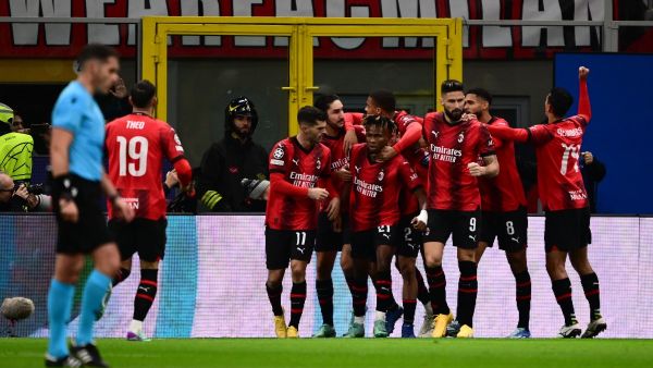 AC Milan's Nigerian midfielder #21 Samuel Chukwueze celebrates with teammates after scoring the team's first goal during the UEFA Champions League Group F football match between AC Milan and Borussia Dortmund at the San Siro stadium in Milan on November 28, 2023. (Photo by Marco BERTORELLO / AFP)
