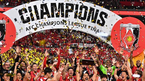 Urawa Red Diamonds players celebrate with the trophy after their victory against Al-Hilal in the second leg of the AFC Champions League final at Saitama Stadium in Saitama on May 6, 2023. (Photo by Philip FONG / AFP)