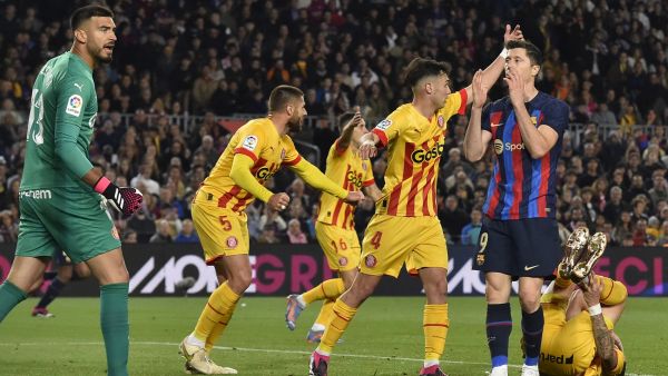 Barcelona's Polish forward Robert Lewandowski (2R) reacts to missing a chance to score during the Spanish league football match between FC Barcelona and Girona FC at the Camp Nou stadium in Barcelona on April 10, 2023. (Photo by Pau BARRENA / AFP)