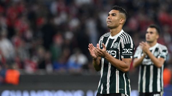 Manchester United's Brazilian midfielder #18 Casemiro and Manchester United's Spanish defender #15 Sergio Reguilon applaud after the UEFA Champions League Group A football match FC Bayern Munich v Manchester United in Munich, southern Germany on September 20, 2023. (Photo by CHRISTOF STACHE / AFP)