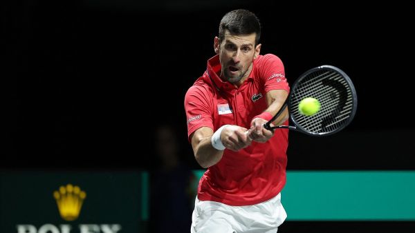 Serbia's Novak Djokovic returns the ball against Italy's Jannik Sinner during the second men's singles semifinal tennis match between Italy and Serbia of the Davis Cup tennis tournament at the Martin Carpena sportshall, in Malaga on November 25, 2023. (Photo by LLUIS GENE / AFP)