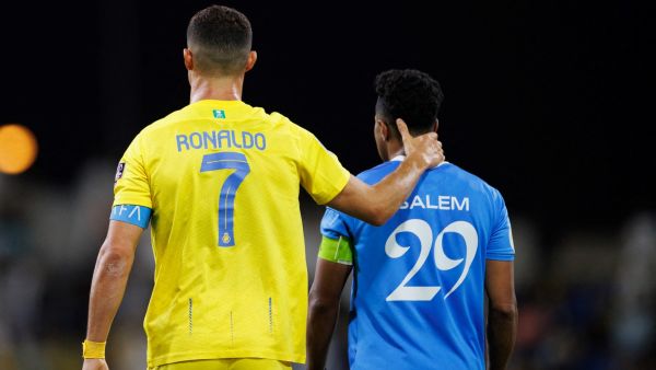 Nassr's Portuguese forward #07 Cristiano Ronaldo speaks with Hilal's Saudi midfielder #29 Salem al-Dawsari during the 2023 Arab Club Champions Cup final football match between Saudi Arabia's Al-Hilal and Al-Nassr at the King Fahd Stadium in Taif on August 12, 2023. (Photo by AFP)