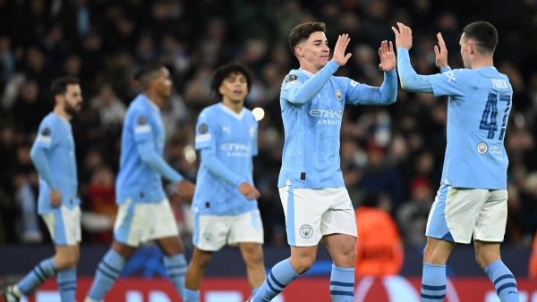 Manchester City's Argentinian striker #19 Julian Alvarez (2R) celebrates scoring the team's third goal with Manchester City's English midfielder #47 Phil Foden during the UEFA Champions League Group G football match between Manchester City and RG Leipzig at the Etihad Stadium, in Manchester, north west England, on November 28, 2023. (Photo by Oli SCARFF / AFP)