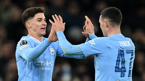 Manchester City's Argentinian striker #19 Julian Alvarez (L) celebrates scoring the team's third goal with Manchester City's English midfielder #47 Phil Foden during the UEFA Champions League Group G football match between Manchester City and RG Leipzig at the Etihad Stadium, in Manchester, north west England, on November 28, 2023. (Photo by Oli SCARFF / AFP)