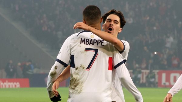 Paris Saint-Germain's French forward #07 Kylian Mbappe is congratulated by Paris Saint-Germain's Portuguese midfielder #17 Vitinha after scoring his team's first goal during the French L1 football match between Lille LOSC and Paris Saint-Germain (PSG) at Stade Pierre-Mauroy in Villeneuve-d'Ascq, northern France on December 17, 2023. (Photo by DENIS CHARLET / AFP)
