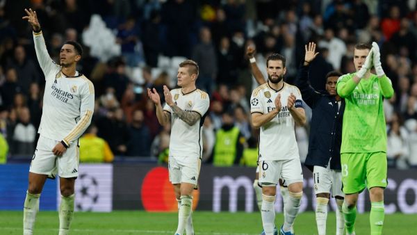 Real Madrid players celebrate at the end of the UEFA Champions League first round group C football match between Real Madrid CF and SSC Naples at the Santiago Bernabeu stadium in Madrid on November 29, 2023. (Photo by OSCAR DEL POZO / AFP)