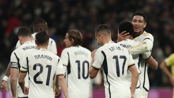 Real Madrid's Brazilian forward #11 Rodrygo is congratulated by Real Madrid's English midfielder #5 Jude Bellingham for scoring his team's second goal during the Spanish league football match between Real Madrid CF and Villarreal CF at the Santiago Bernabeu stadium in Madrid on December 17, 2023. (Photo by Thomas COEX / AFP)