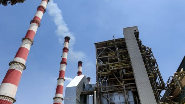 This picture taken on July 10, 2022 shows a view of the chimneys at the thermal natural gas and fuel-oil power plant serving Syria's northern city of Aleppo, about eight kilometres east of the city, which has recently been restored after being mothballed during the ongoing conflict. (Photo by AFP) Syria