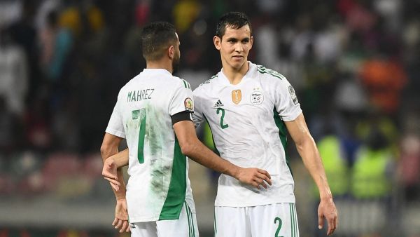 Algeria's forward Riyad Mahrez (L) and Algeria's defender Aissa Mandi (R) react after Ivory Coast won the Group E Africa Cup of Nations (CAN) 2021 football match between Ivory Coast and Algeria at Stade de Japoma in Douala on January 20, 2022. (Photo by CHARLY TRIBALLEAU / AFP)