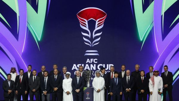 FIFA President Gianni Infantino (C-L) and President of the Asian Football Confederation (AFC) Sheikh Salman bin Ibrahim al-Khalifa (C-R) pose for a picture with the trophy and coaches during the draw for the AFC Asian Cup in Doha on May 11, 2023. (Photo by KARIM JAAFAR / AFP)