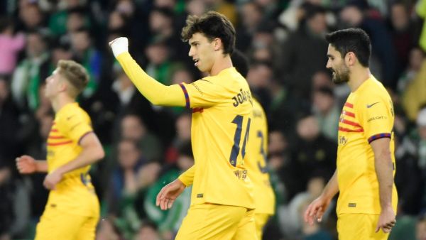 Barcelona's Portuguese forward #14 Joao Felix (C) celebrates scoring his team's third goal during the Spanish League football match between Real Betis and FC Barcelona at the Benito Villamarin stadium in Seville on January 21, 2024. (Photo by CRISTINA QUICLER / AFP)