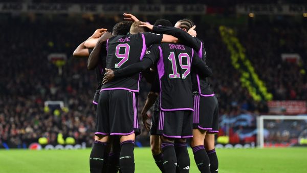 Bayern Munich's players celebrate the opening goal scored by Bayern Munich's French forward #11 Kingsley Coman during the UEFA Champions League group A football match between Manchester United and FC Bayern Munich at Old Trafford stadium in Manchester, north west England, on December 12, 2023. (Photo by PETER POWELL / AFP)