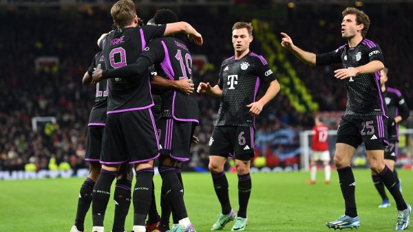 Bayern Munich's players celebrate the opening goal scored by Bayern Munich's French forward #11 Kingsley Coman during the UEFA Champions League group A football match between Manchester United and FC Bayern Munich at Old Trafford stadium in Manchester, north west England, on December 12, 2023. (Photo by PETER POWELL / AFP)
