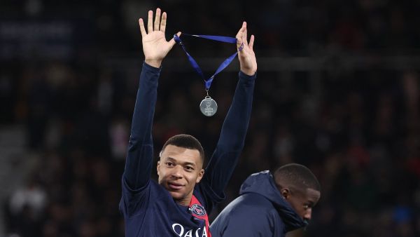 Paris Saint-Germain's French forward #07 Kylian Mbappe celebrates with his medal after winning the French Champions' Trophy (Trophee des Champions) football match between Paris Saint-Germain (PSG) and Toulouse FC at the Parc des Princes stadium in Paris on January 3, 2024. (Photo by FRANCK FIFE / AFP)
